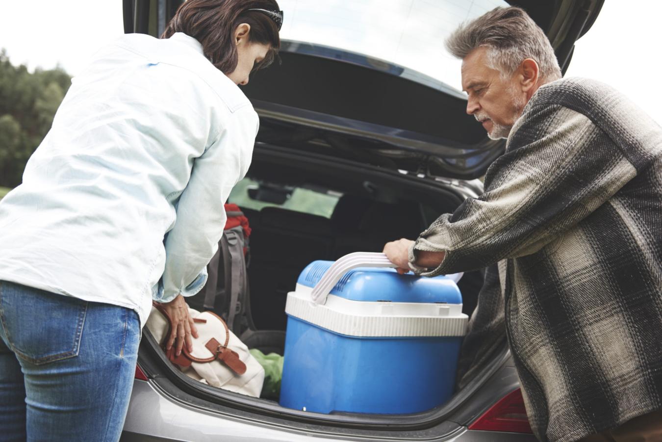 people unloading a car at a campsite